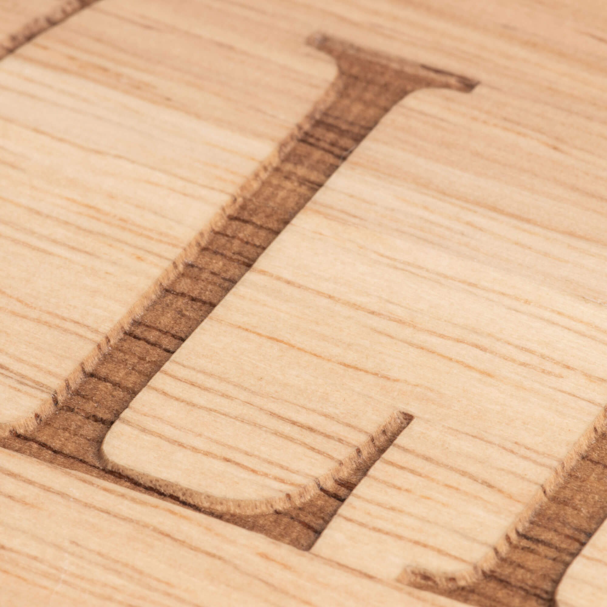 Closeup of Design engraved on a maple wood texture