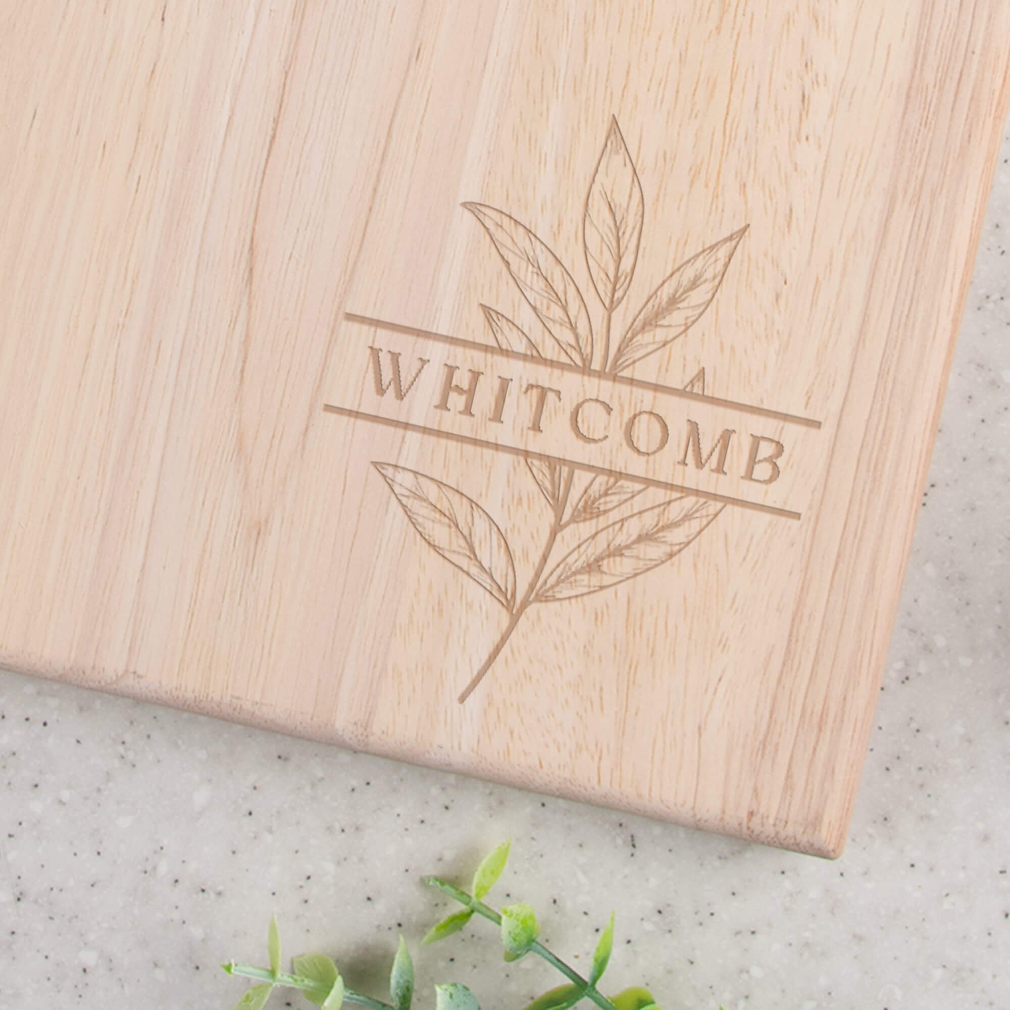 Engraved Family Name Cutting Board Paddle Style closeup of design in bottom right corner