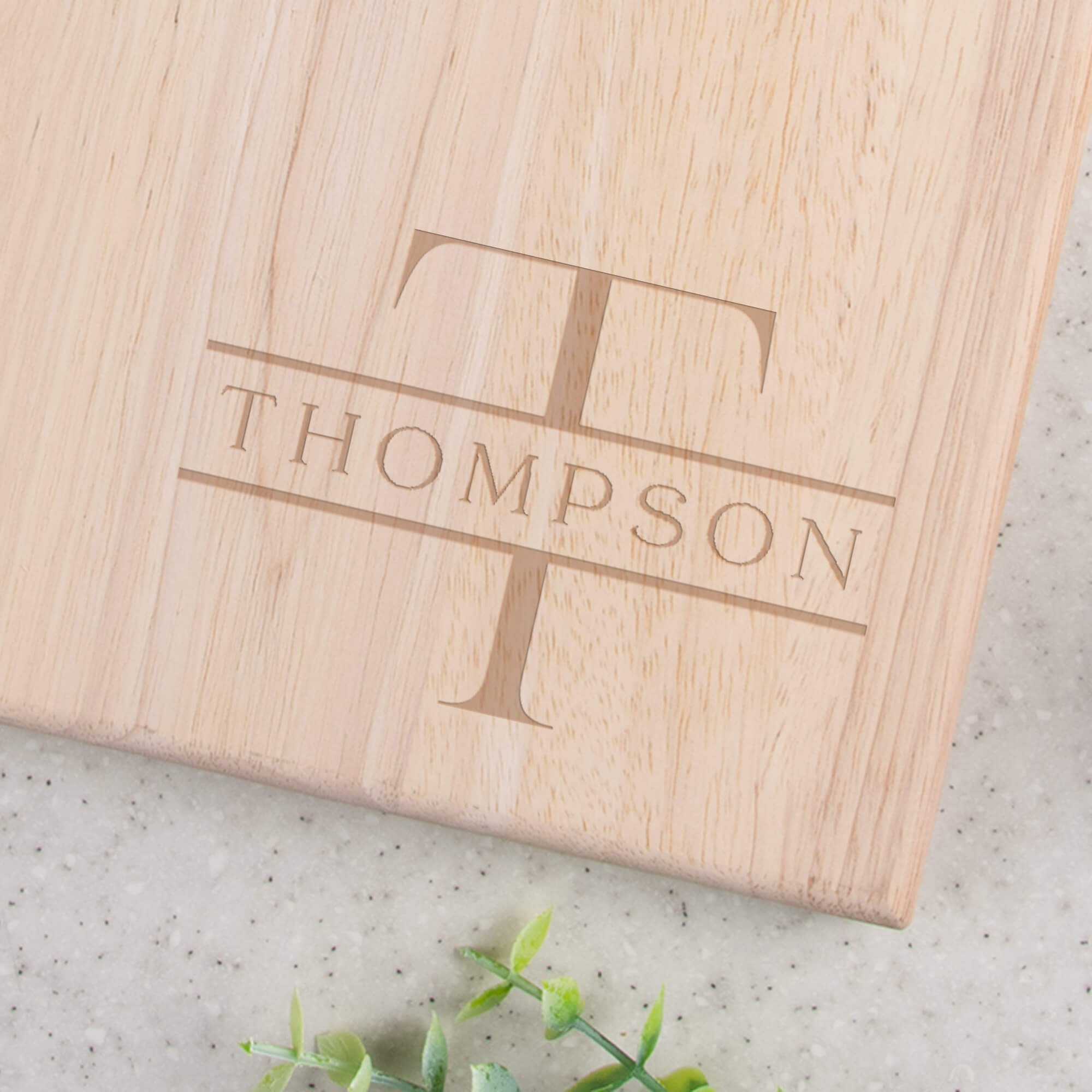 Custom Family Monogram Engraved Paddle Serving Board closeup of design on bottom right corner
