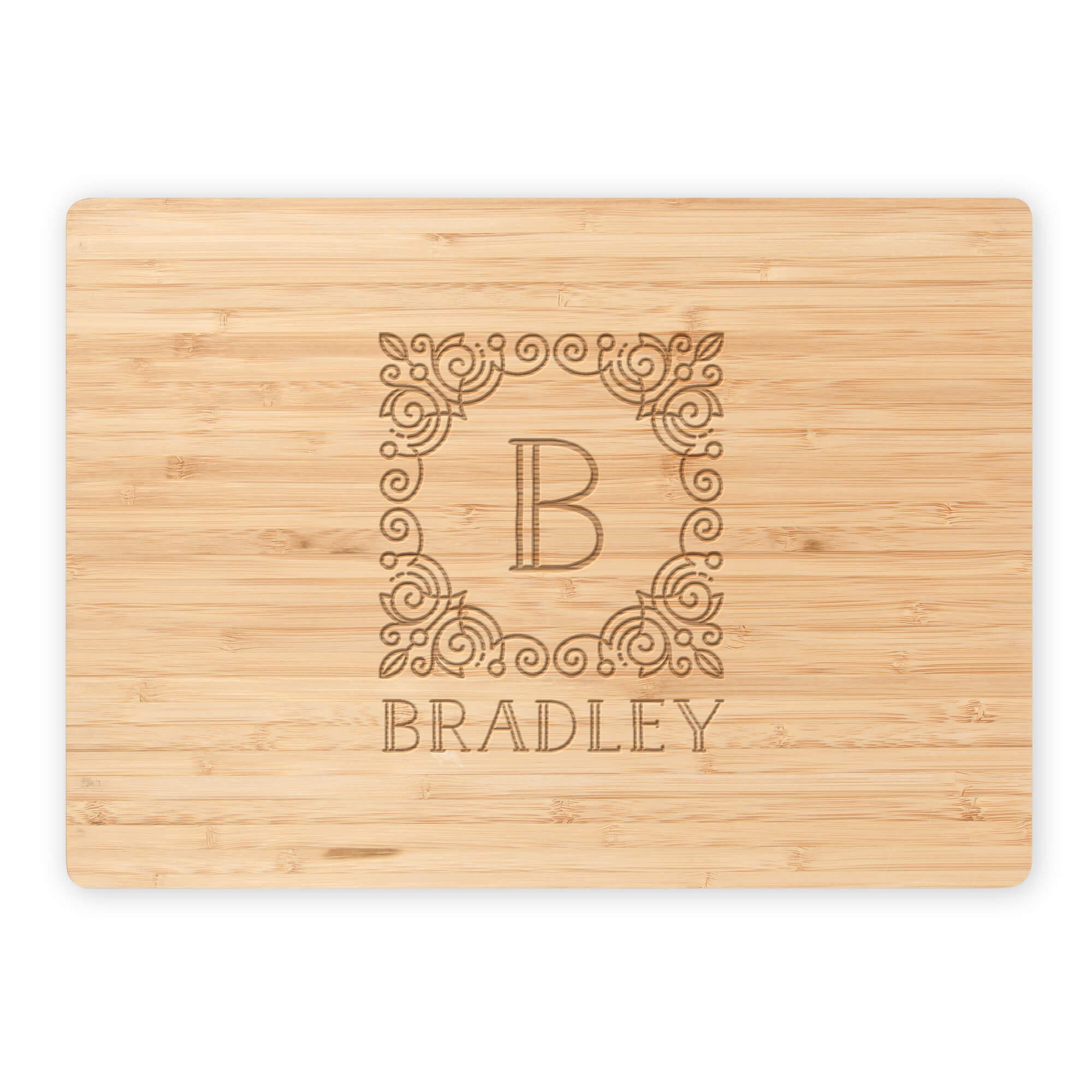 Engraved bamboo cutting board with detailed B monogram and Bradley name, isolated on white background