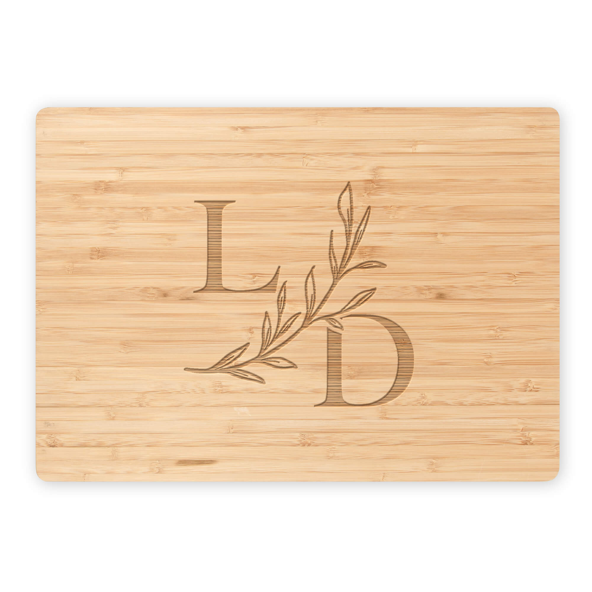 Bamboo cutting board with serif L and D initials and botanical branch on white background