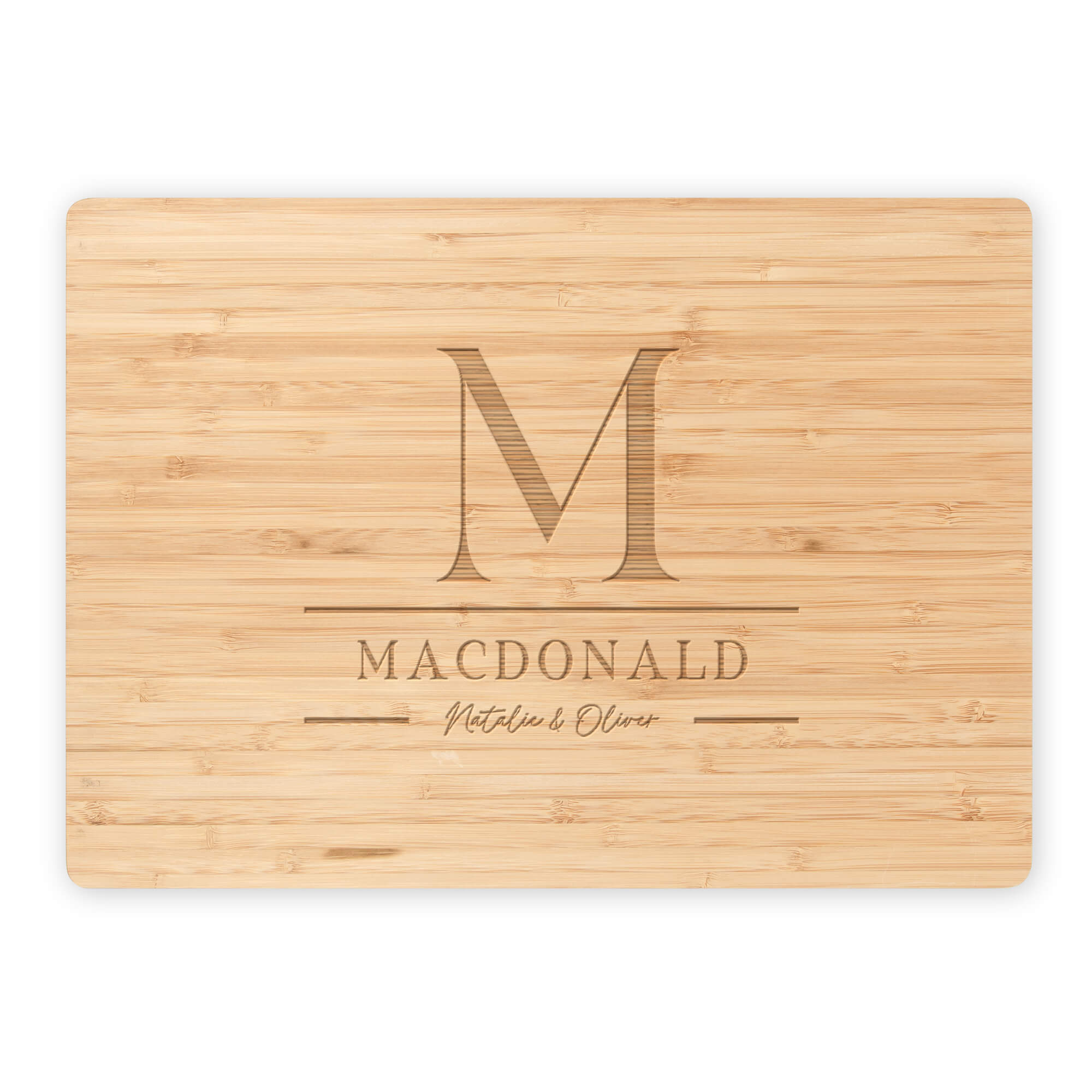 Bamboo cutting board featuring engraved M monogram, MacDonald family name, and script names Natalie & Oliver on white background