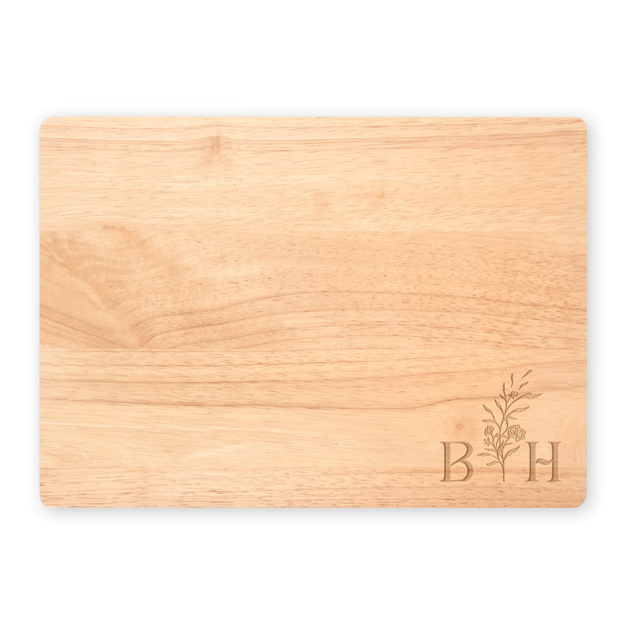 B H Floral Initials engraved into a large maple cutting board on a white background
