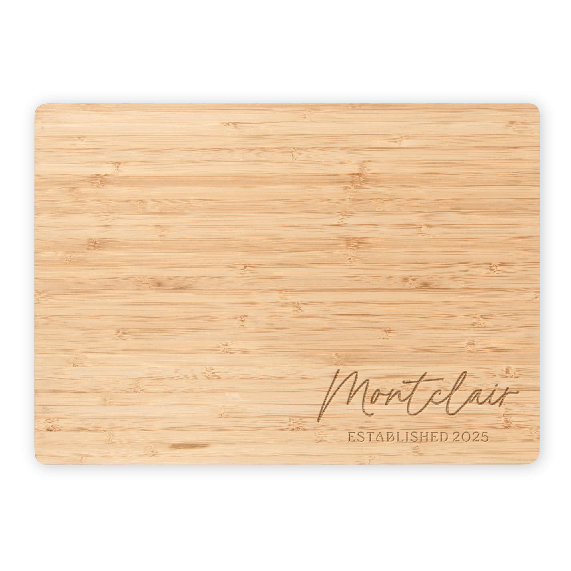 Personalized bamboo cutting board engraved with “Montclair Established 2025.” Custom engraved family name cutting board or eco-friendly kitchen gift idea.