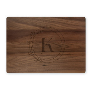 Walnut cutting board with circle monogram K on white background