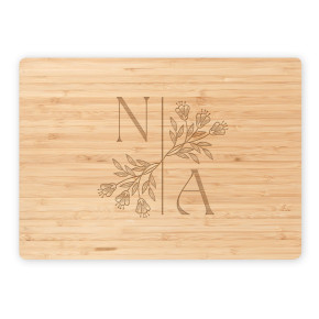Bamboo cutting board with N | A split initials and floral branch on white background