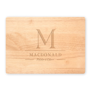 Maple cutting board featuring engraved M monogram, MacDonald family name, and script names Natalie & Oliver on white background