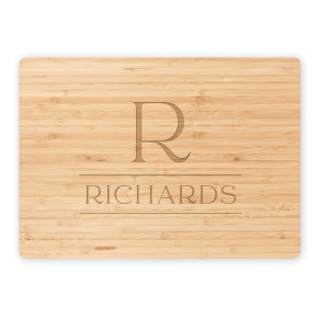 Bamboo cutting board featuring engraved serif R monogram and Richards family name on white background