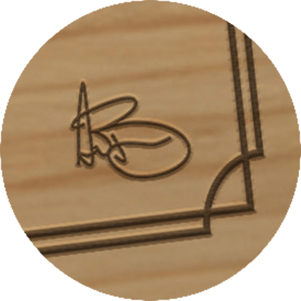 Closeup of AJ Buckley's signature engraved into the board