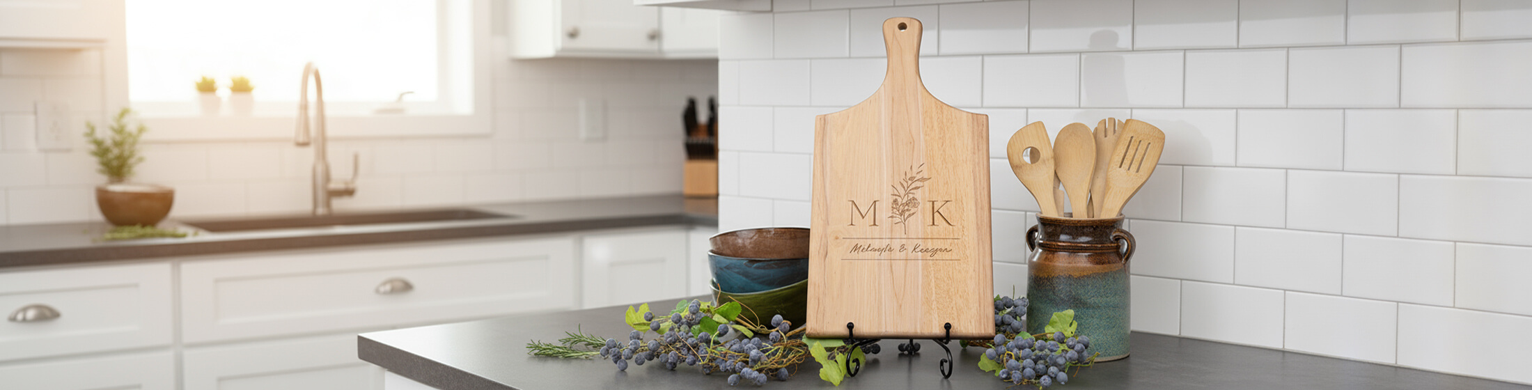Close-up of a personalized wooden cutting board engraved with the name 'Montclair' in script